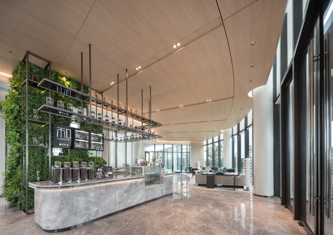 Modern coffee shop with living plant wall and marble counter.