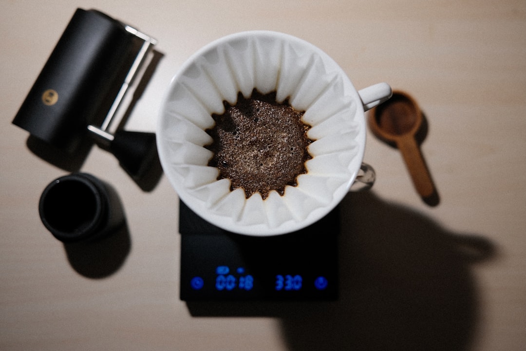 a cup of coffee sitting on top of a scale - Baratza vs Fellow grinder comparison