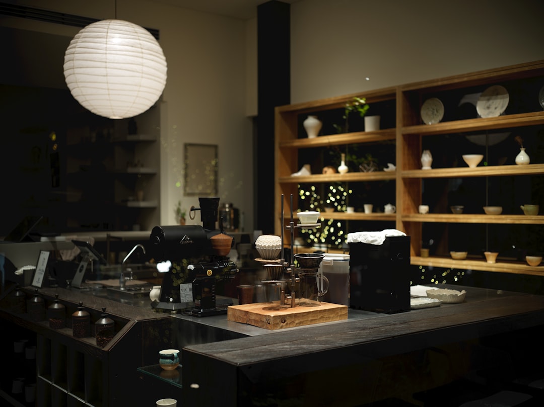 Interior of a modern cafe with shelves displaying ceramics.
