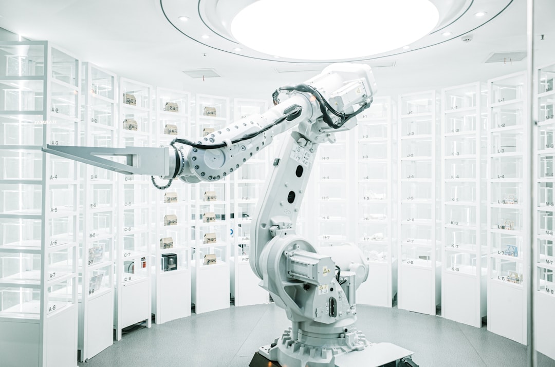 A white six-axis robotic arm reaches into a wall of illuminated glass display cabinets inside an automated retail showroom.