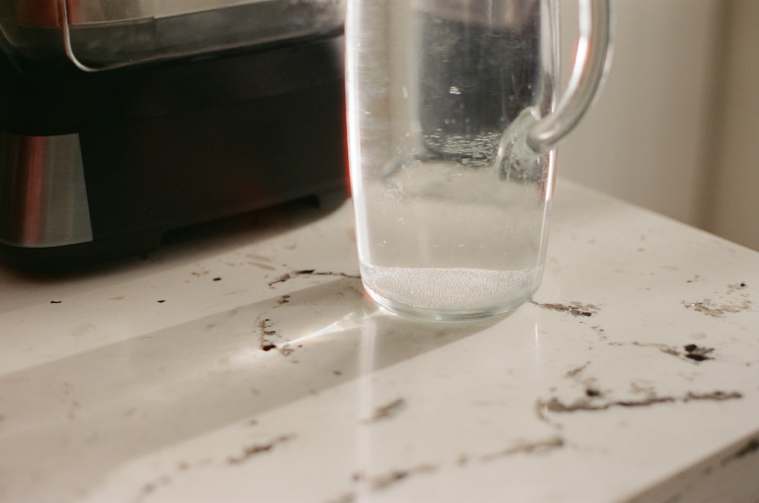 Clear glass pitcher of water on a kitchen counter, the ingredient every coffee brewing decision starts with