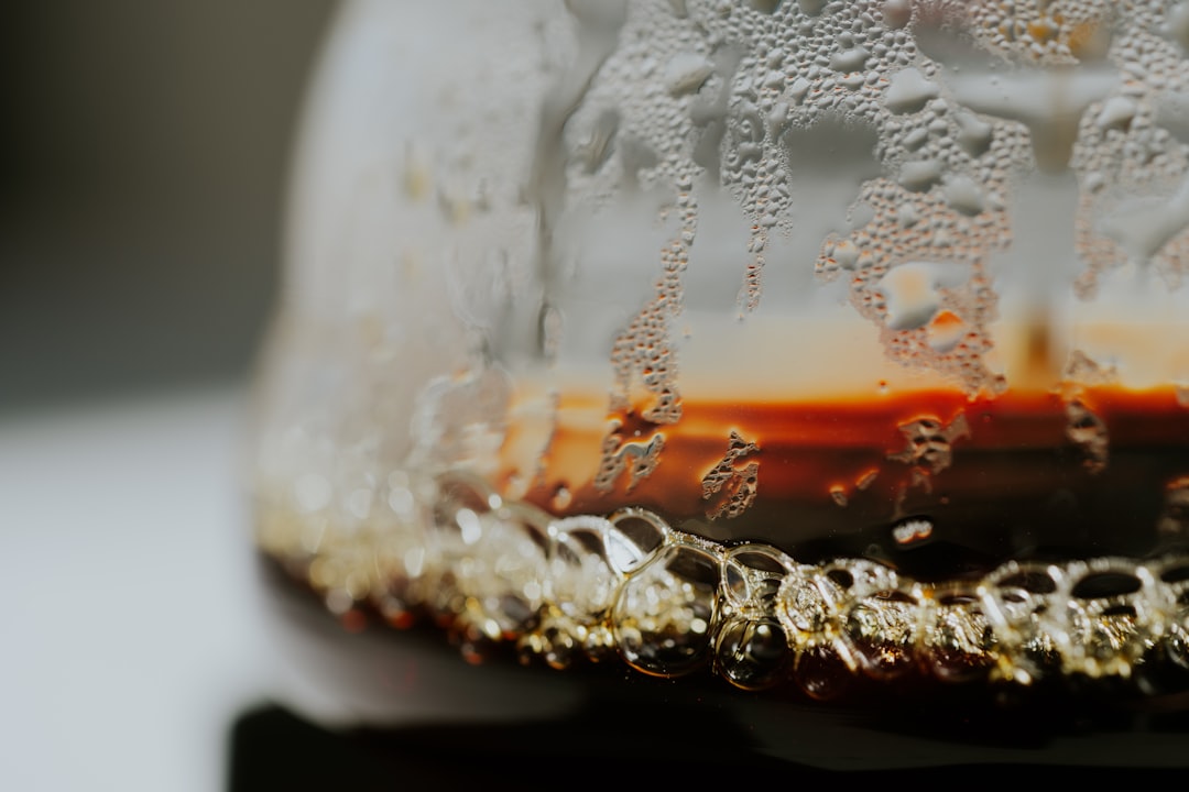 close-up of Turkish coffee being poured, showing rich foam and dark liquid in a traditional cup