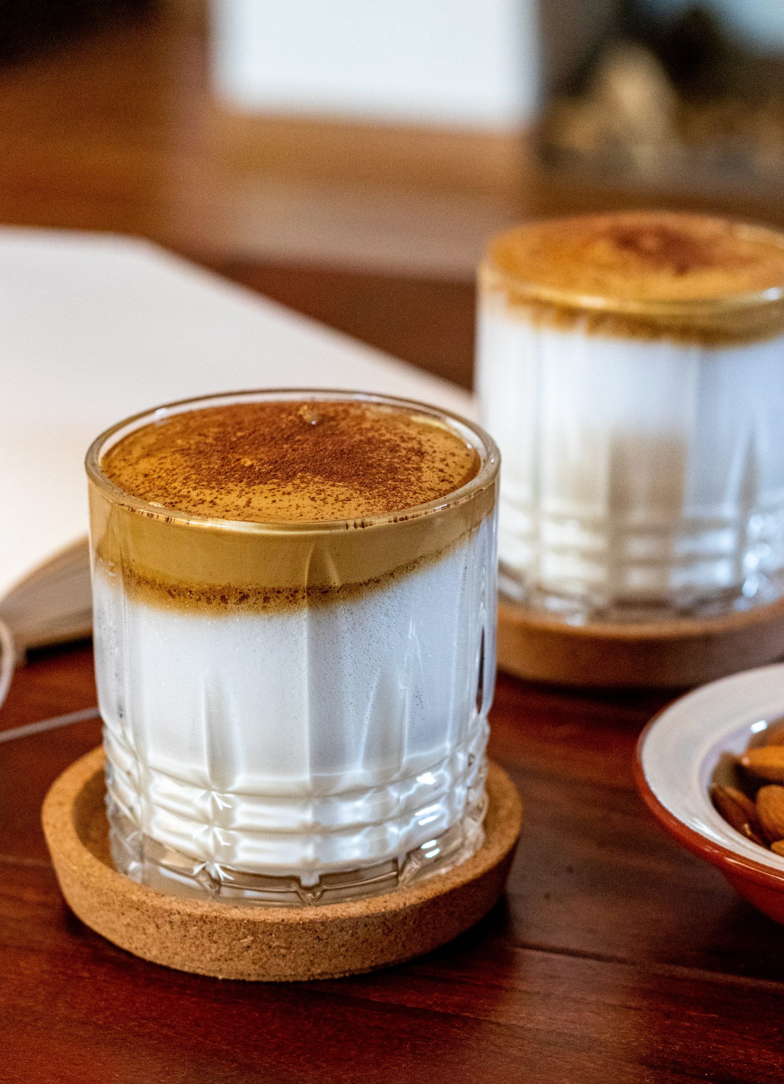 Whipped coffee foam spooned over milk
